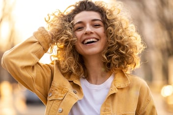 curly hair girl with yellow jacket